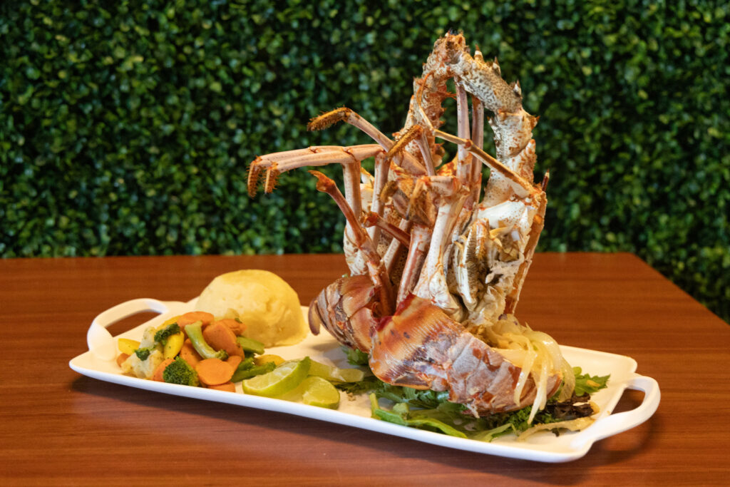 Whole lobster with mofongo and vegetables