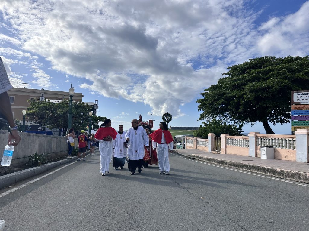 The priests escorting the San Sebastian statue to the starting point